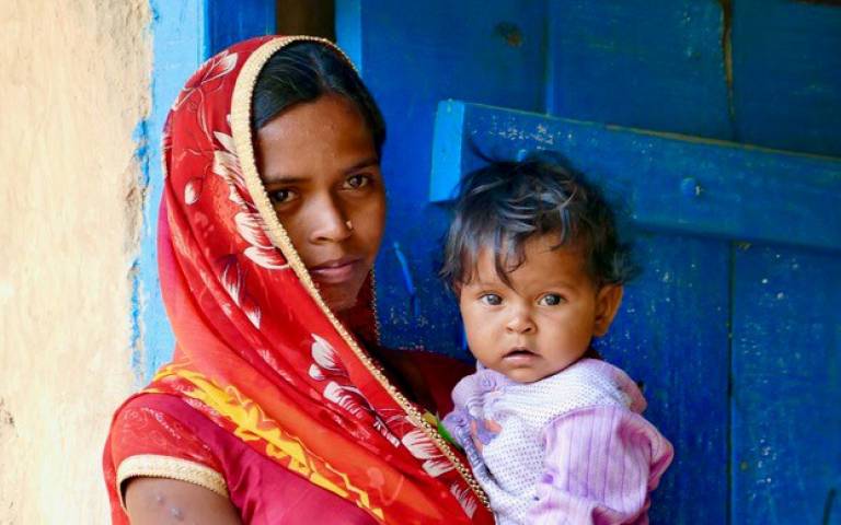 Mother in India holding her young child