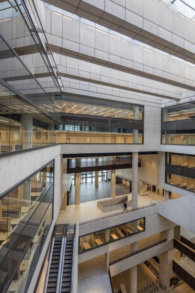Interior of UCL East Marshgate building looking down from upper floors to lower floors, escalator and atrium