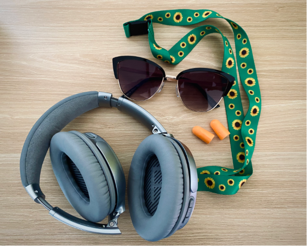 Headphones, sunglasses and a sunflower lanyard