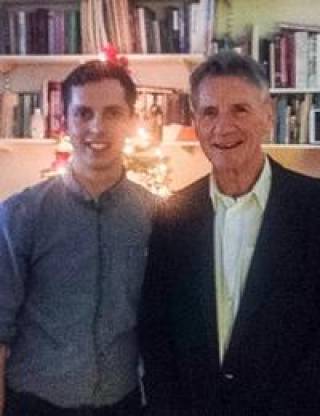 Oli Cheadle being presented with his award by Michael Palin