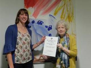 Philippa Clay receiving her award certificate from her supervisor Jane Maxim