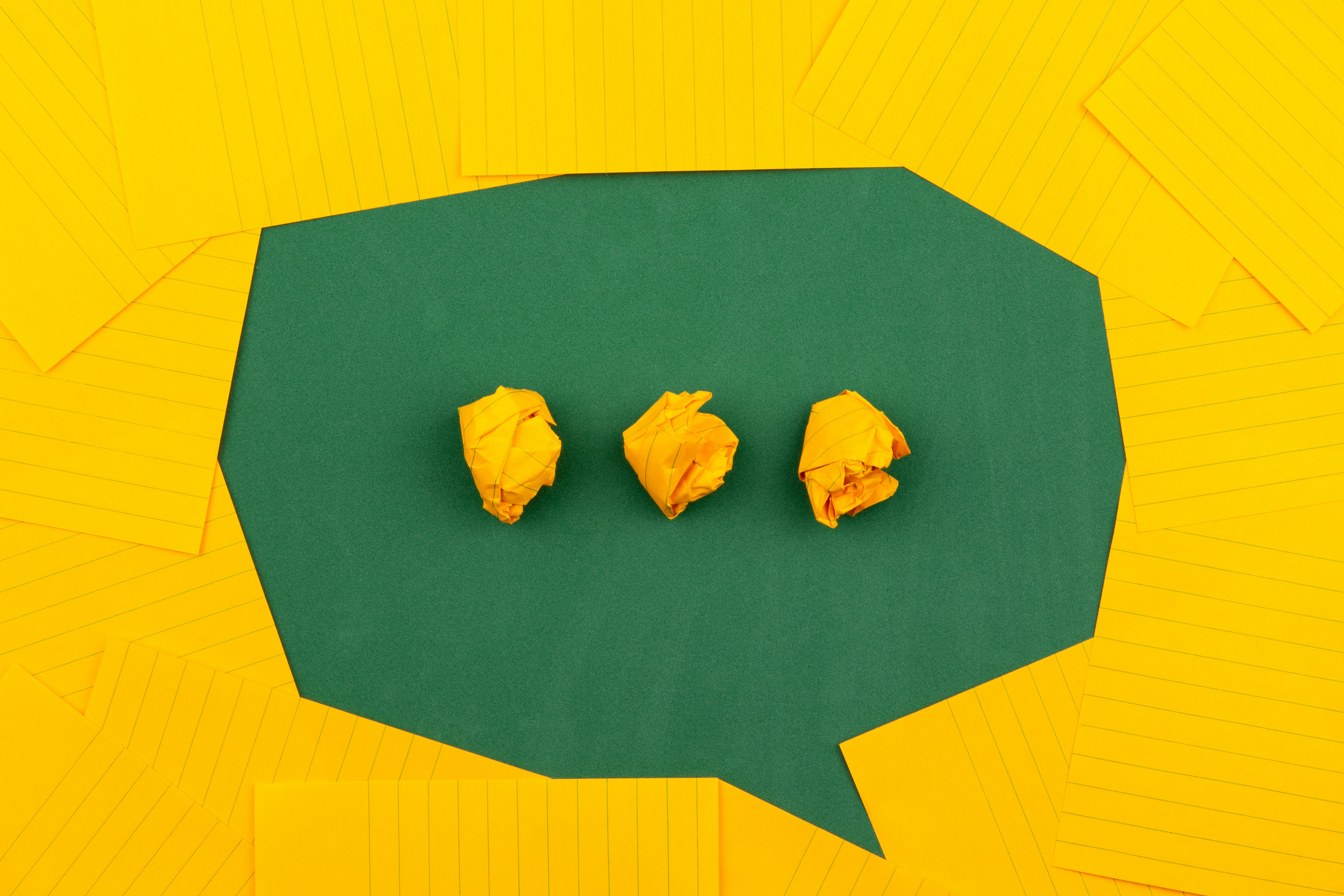 A green speech bubble on a yellow background