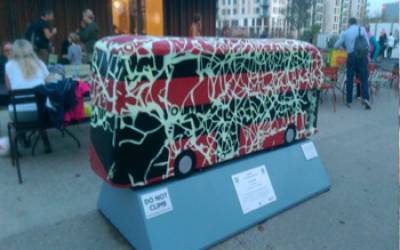 A piece of art showing a London bus covered in light green markings