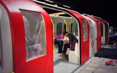 A tube train model with someone sitting inside