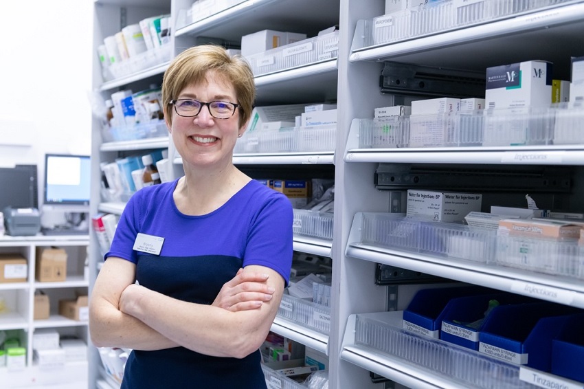 Prof Bryony Dean Franklin standing in front of shelves filled with pharmaceutical products
