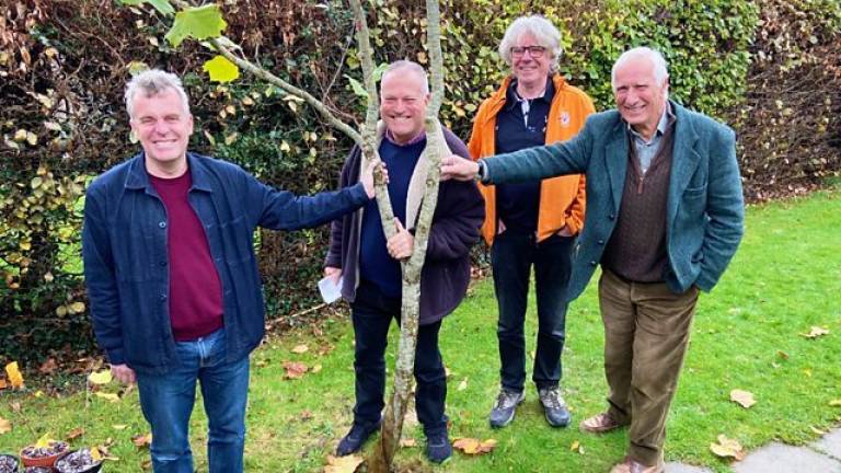 4 men standing by a small tree in a garden in Flamstead, Bedfordshire, including Professor Steve Miller (far right)
