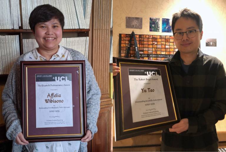 Affelia Wibisono and Yu Tao holding their framed awards