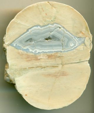Limestone concretion with a geometrically-centred zone of agate, possibly from chemically-oscillating reactions.