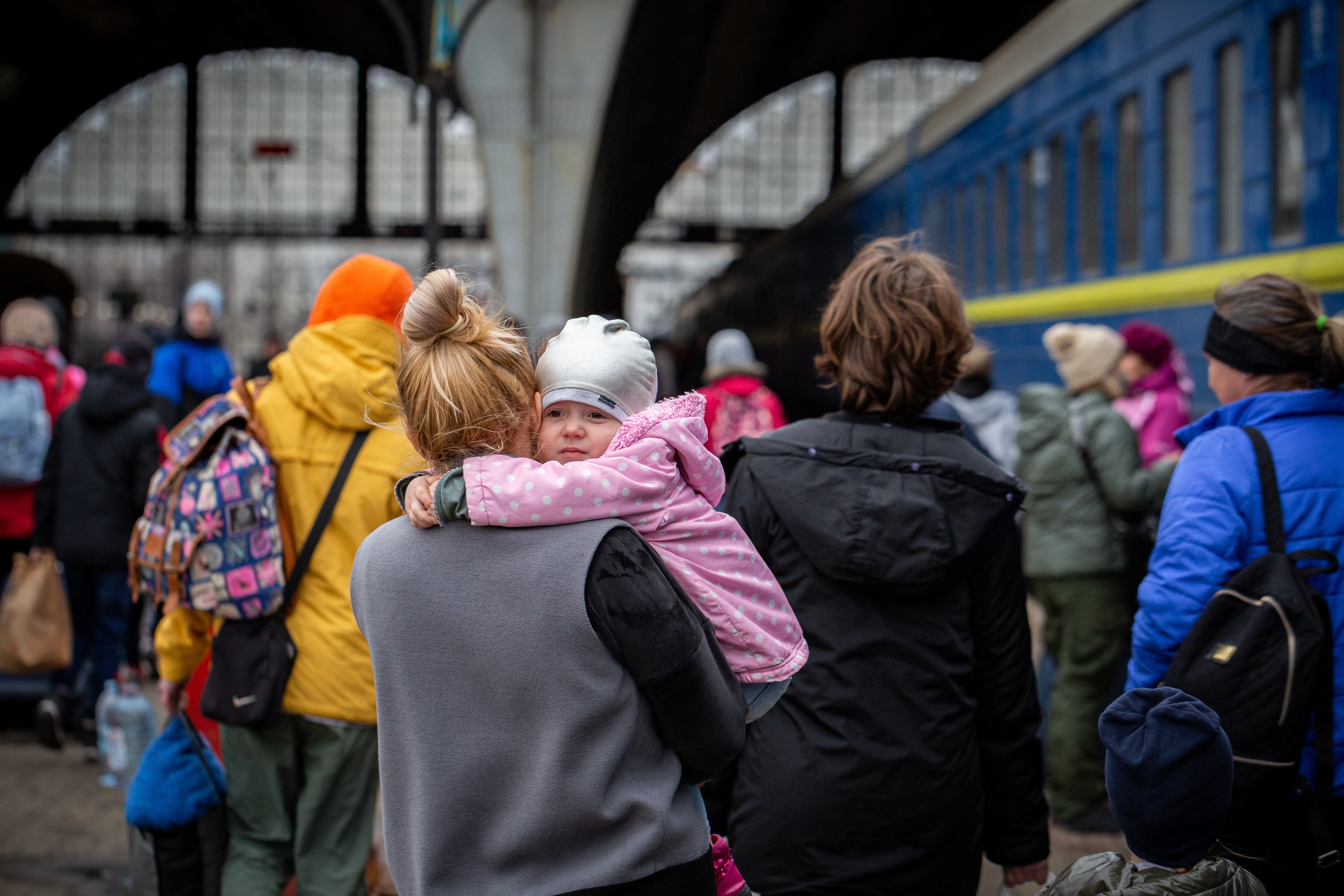 Ukrainian mother and child on a train platform