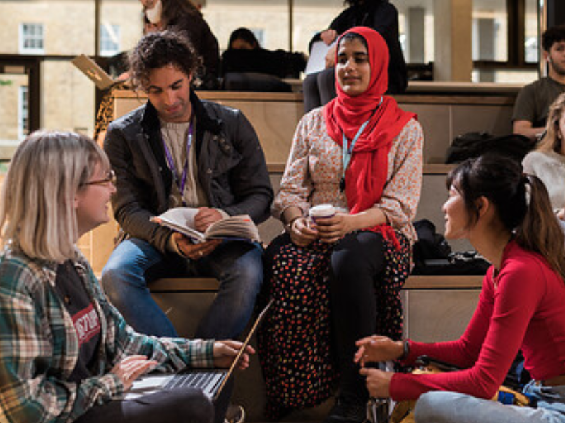 A group of students talk in the UCL student centre