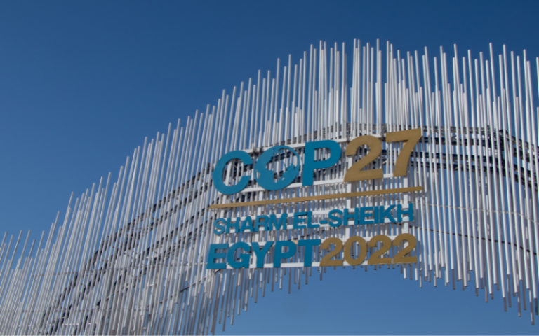 The COP27 logo in Sharm El-Sheik, with blue sky in the background