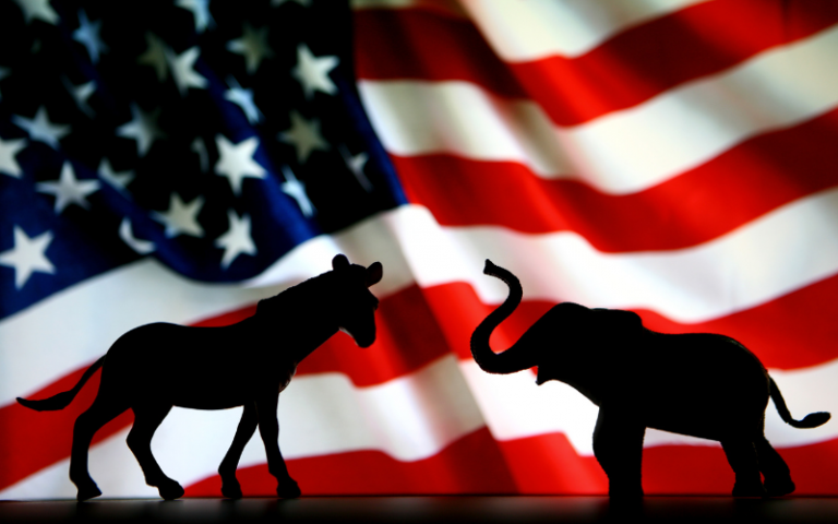 Silhouette of Democrat donkey and Republican elephant in front of the USA flag