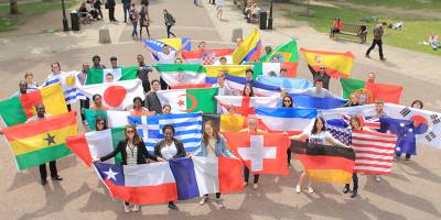 International students with flags in the UCL Quad
