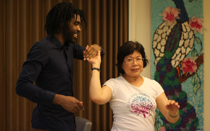 A student dancing with a participant at an event.
