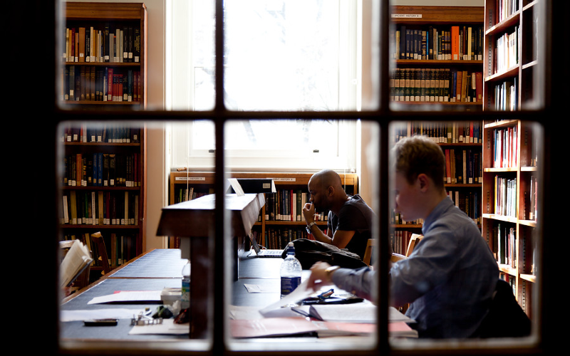 Students studying and reading in a UCL Library.