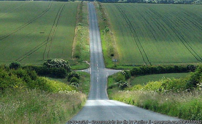 Image: Crossroads in the dip, cc-by-sa/2.0 - © Pauline E - geograph.org.uk/p/3559592
