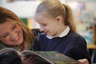 Girl reading with mum