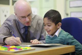 Teacher and a boy at Reading Recovery lesson