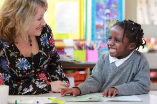 teacher with a child at the Reading Recovery lesson