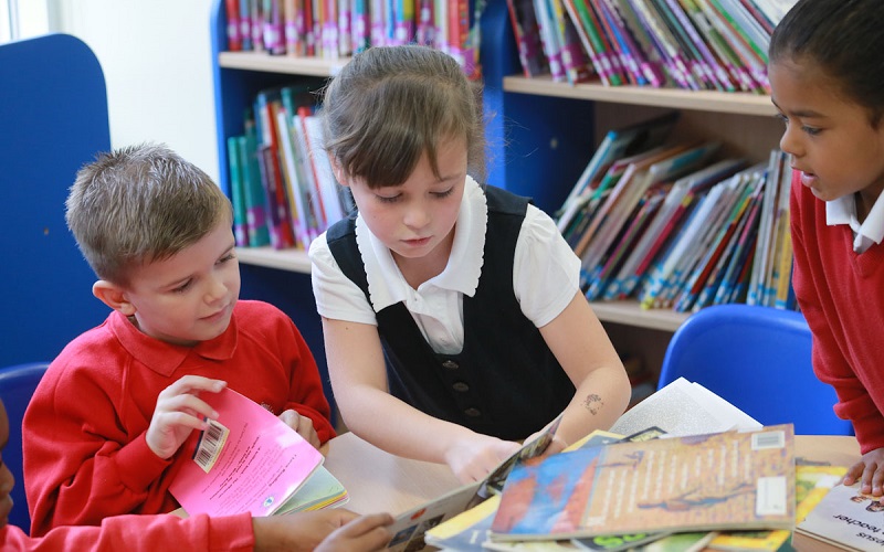 group of children selecting books in a library