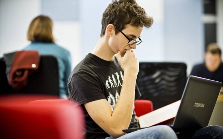 Male student looking at laptop
