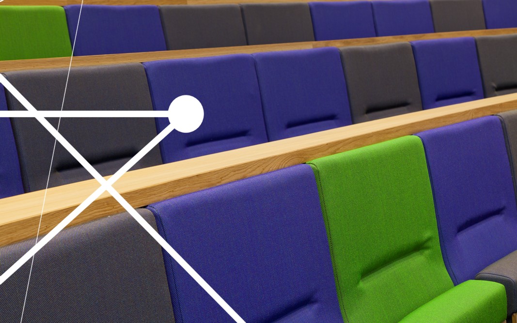 Close up of blue, green and dark grey lecture theatre seats