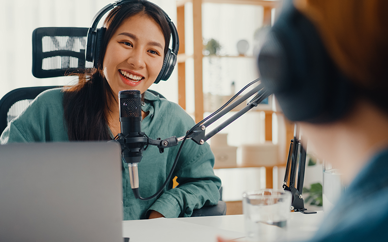 an image of a woman giving an interview for a podcast/radio