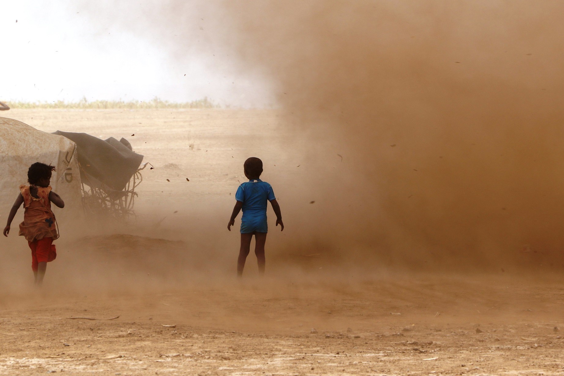 two children in sand storm in Ethiopia