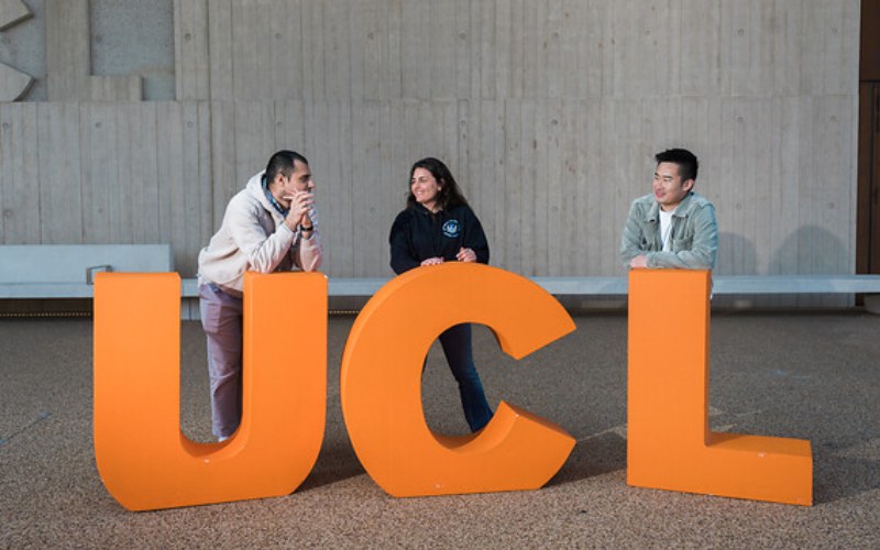 Students standing with large letters spelling UCL