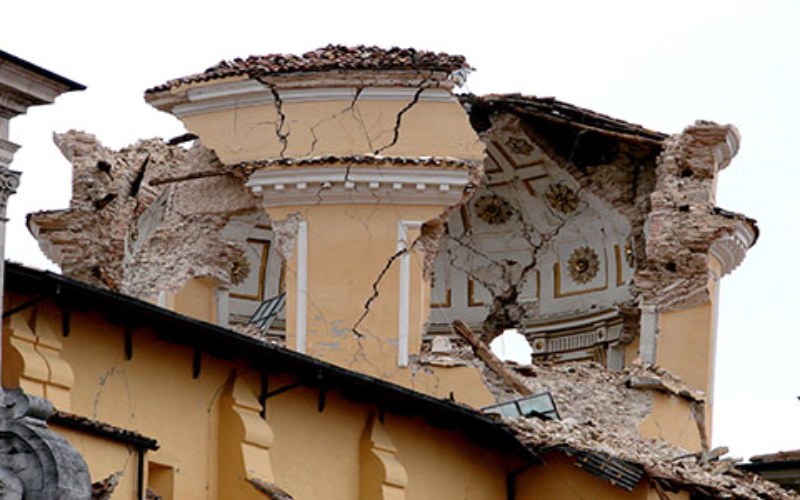 Turret of a plastered building damaged by an earthquake