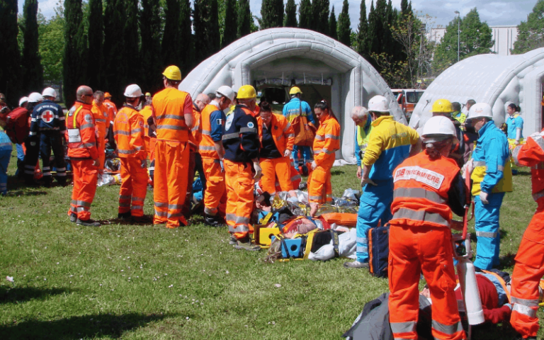 People in orange uniforms setting up rescue supplies