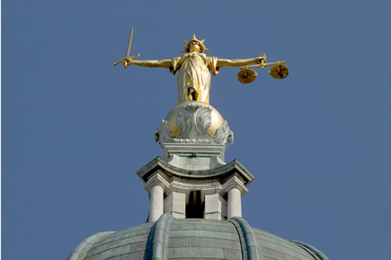 Statue of Justice on a domed roof