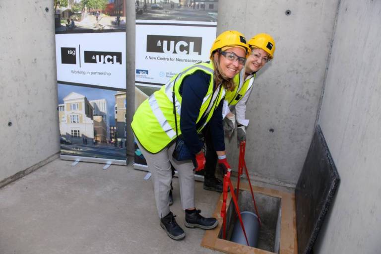 Queen Square Institute of Neurology Manager, Hélène Crutzen and local resident Marianne Jacobs-Lim bury the time capsule at 256 Grays Inn Road