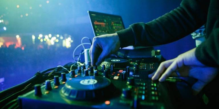 DJ with turntable in nightclub