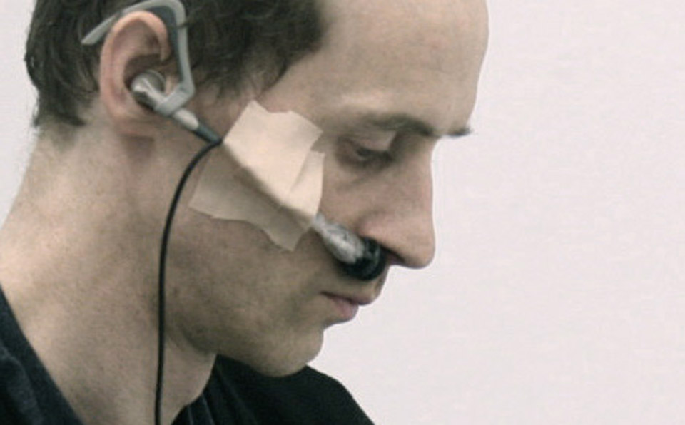 <p>Take air into the lungs and then expel it, 2012<br />
A semi-hidden wireless microphone attached under the invigilator's nose. His/her breathing sound is amplified and come out through speakers.</p>
