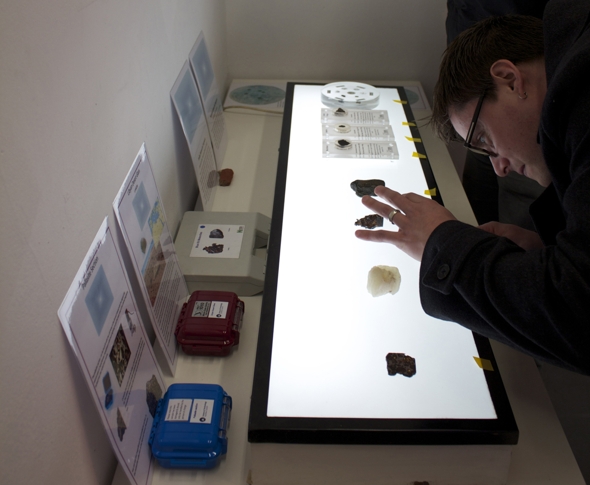 A researcher inspects some desert glass during the Lunar Salon