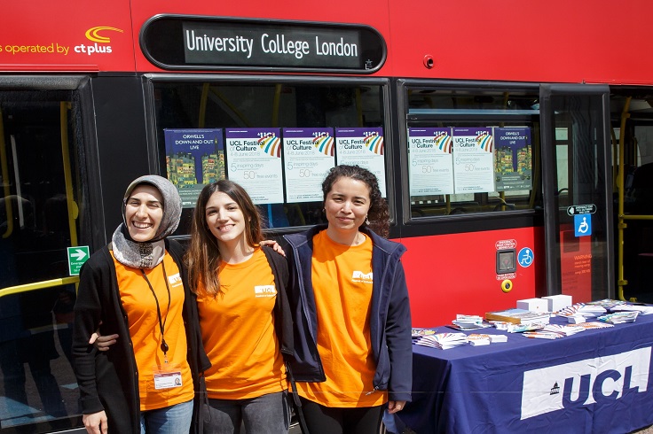 Student helpers stood next to UCL big red bus
