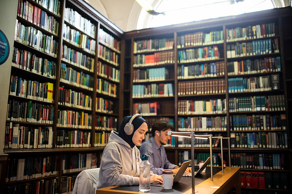 Two students studying in the main library