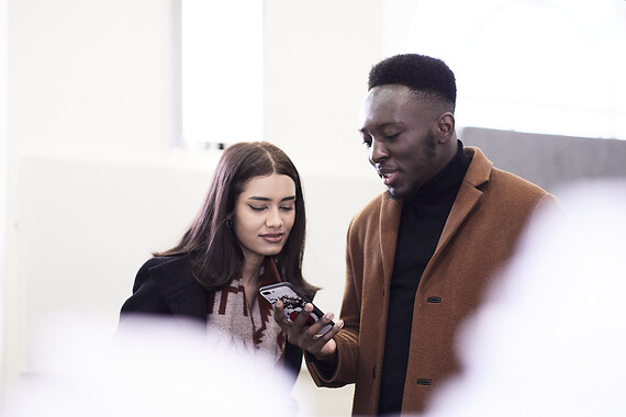 Students looking at a phone