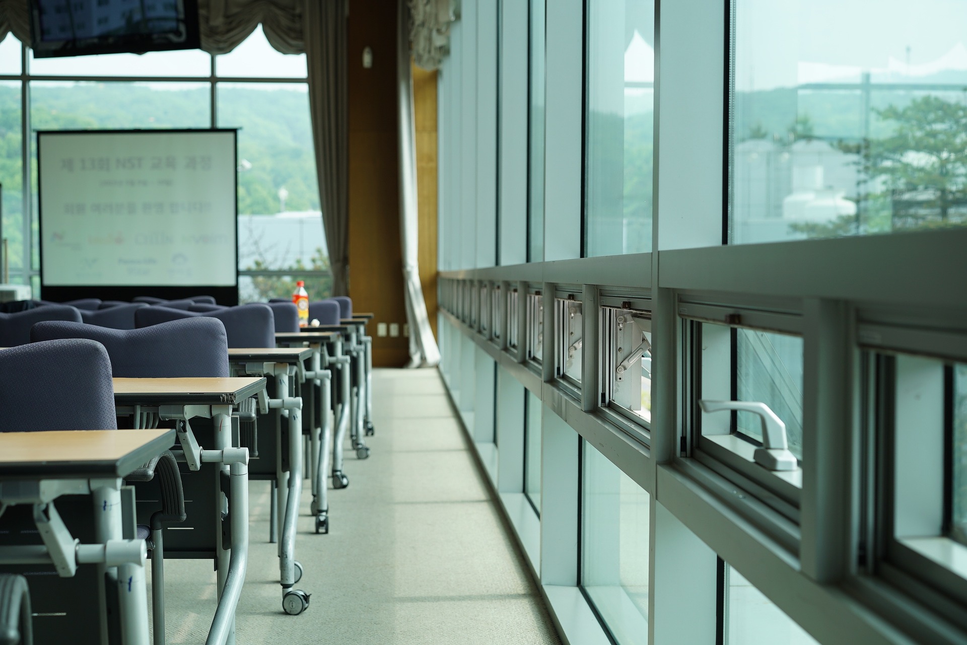 Side of room with chairs and windows in seminar layout. 