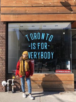 Sophia outside a shop front in Toronto
