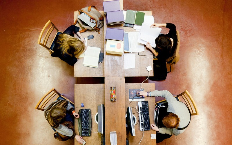 Ariel view of students sat at table in library