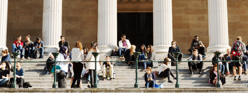 Students sitting on the Portico steps