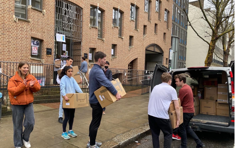 SSEES students transport donations outside the SSEES building