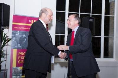 Professor Michael Arthur shakes hands with Professor Jan Kubik…
