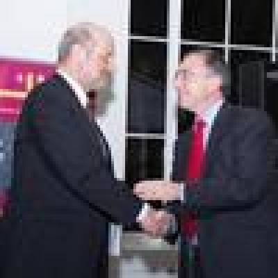 Professor Michael Arthur shakes hands with Professor Jan Kubik…