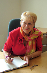 Baiba Rivža signs the Visitor's Book during her visit to SSEES…
