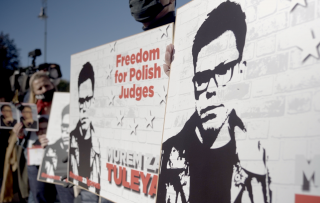 People holding up a banner with the picture of Judge Igor Tuleya