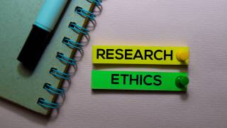 Text 'Research Ethics' next to notebook and pen