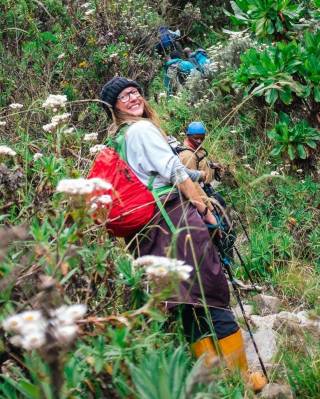 Photo of PhD student, Sarah Bebb, climbing hill